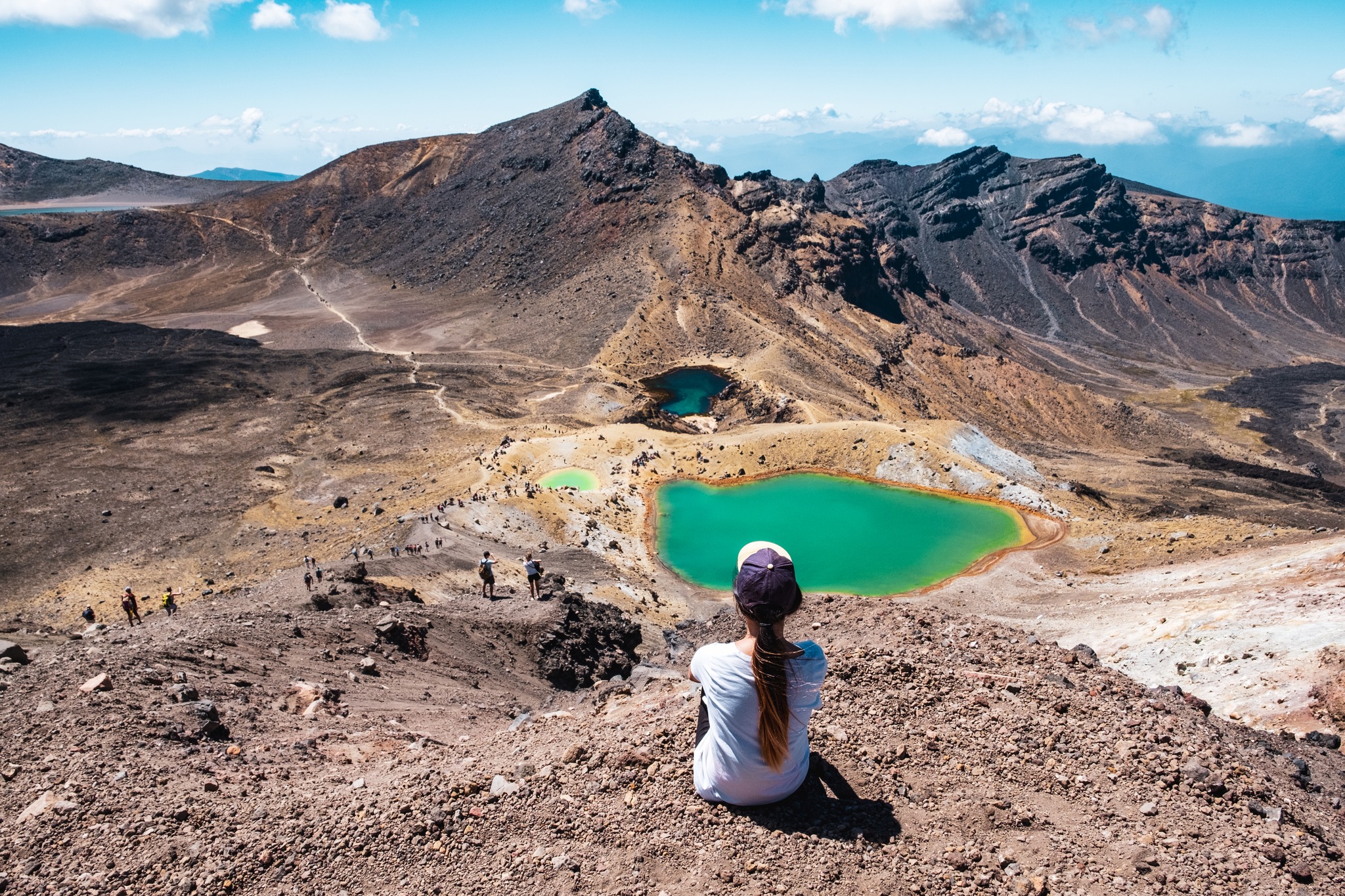 Hiker looking out over the Emerald Lakes on the Tongariro Alpine Crossing